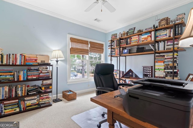 carpeted office with visible vents, crown molding, baseboards, and a ceiling fan