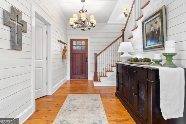 entrance foyer with light wood-type flooring and an inviting chandelier