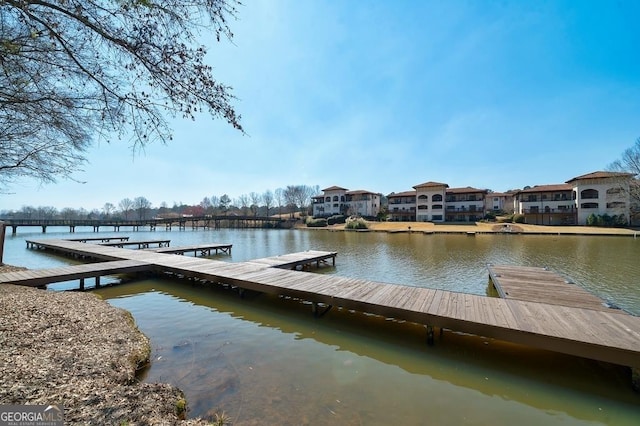 view of dock with a water view and a residential view