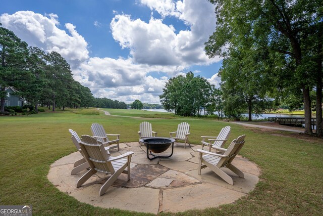 view of patio / terrace featuring a fire pit and a water view