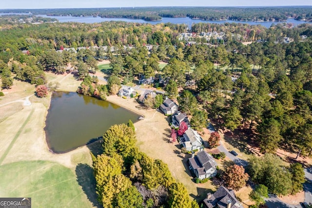 bird's eye view featuring a forest view and a water view