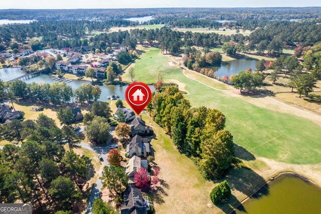 birds eye view of property featuring view of golf course, a water view, and a residential view