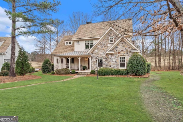 view of front of home with a porch and a front yard