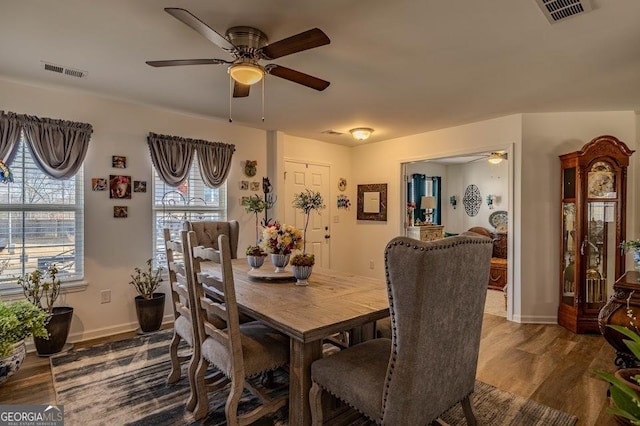 dining area with ceiling fan and hardwood / wood-style flooring