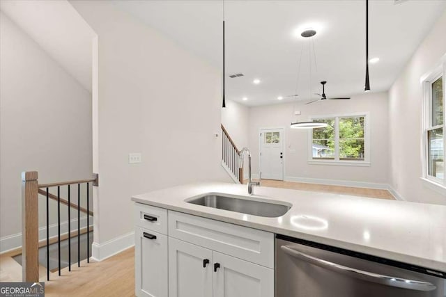 kitchen featuring ceiling fan, sink, stainless steel dishwasher, light hardwood / wood-style floors, and white cabinets