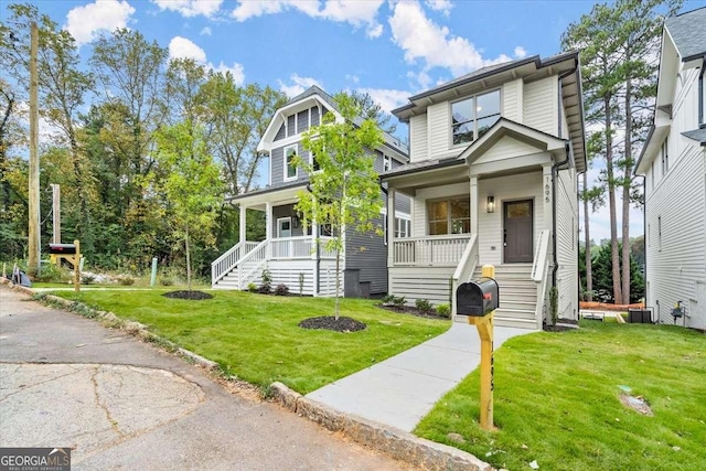 view of front of house with a porch, central AC, and a front lawn