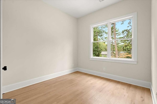 spare room featuring light wood-type flooring