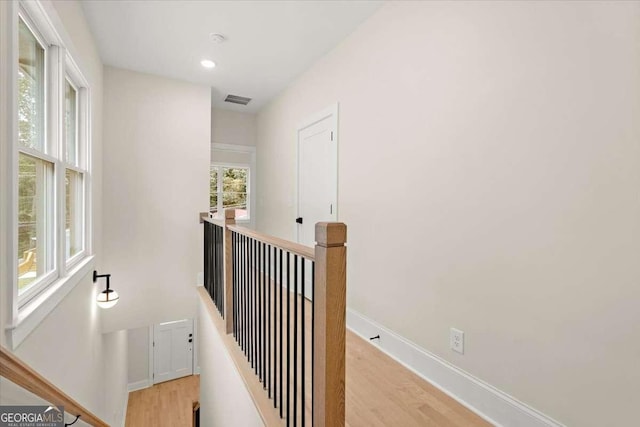 hallway with light hardwood / wood-style flooring