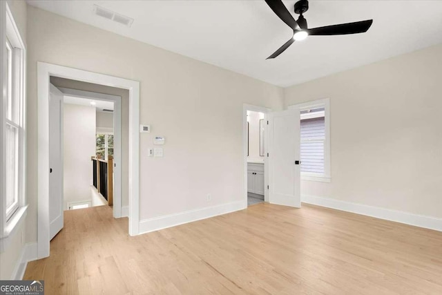 unfurnished bedroom featuring multiple windows, light wood-type flooring, and ceiling fan