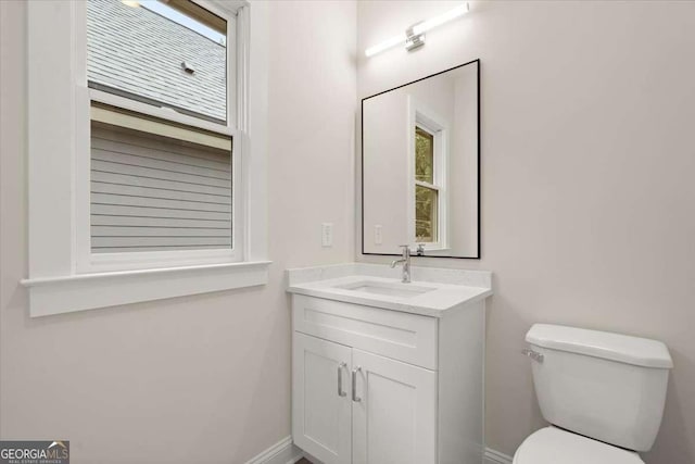 bathroom featuring vanity and toilet