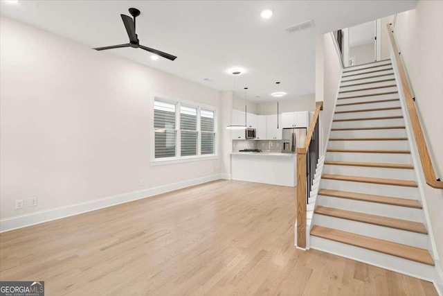 interior space featuring light hardwood / wood-style floors and ceiling fan