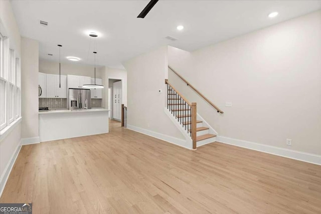 unfurnished living room featuring light hardwood / wood-style floors