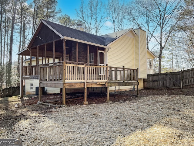 rear view of property with a wooden deck