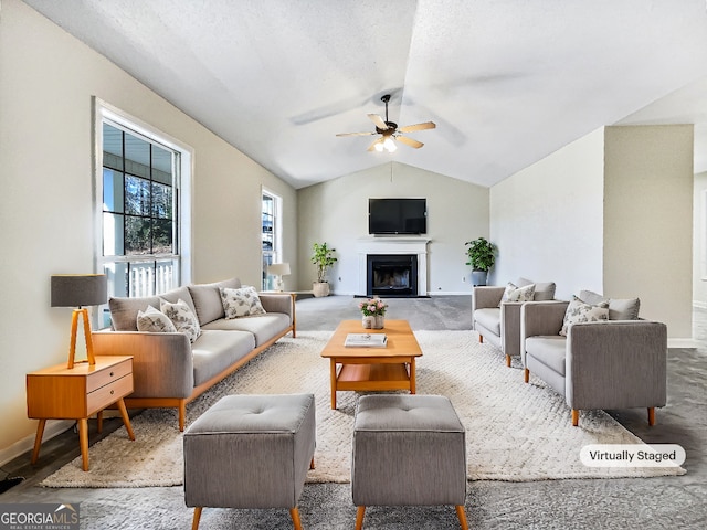 living room featuring ceiling fan and lofted ceiling