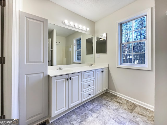 bathroom featuring vanity and a textured ceiling