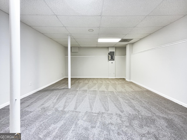 basement with carpet flooring and a paneled ceiling