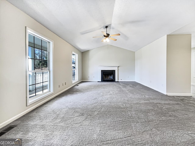 unfurnished living room featuring carpet, ceiling fan, and lofted ceiling