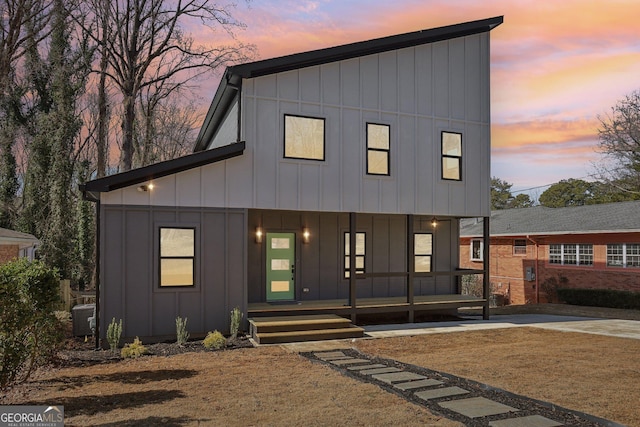 view of front facade featuring central AC unit and covered porch