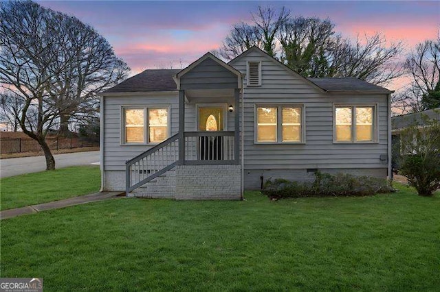 bungalow-style house with a front yard