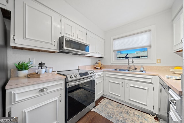 kitchen featuring white cabinets, appliances with stainless steel finishes, dark wood-type flooring, and sink