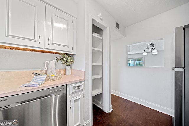 kitchen featuring a textured ceiling, white cabinetry, dark hardwood / wood-style floors, and appliances with stainless steel finishes