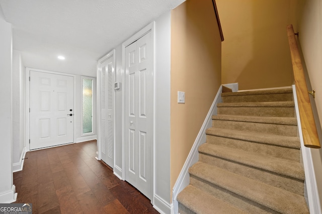 stairs featuring wood-type flooring