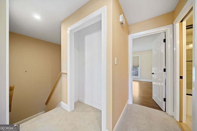 corridor featuring light colored carpet