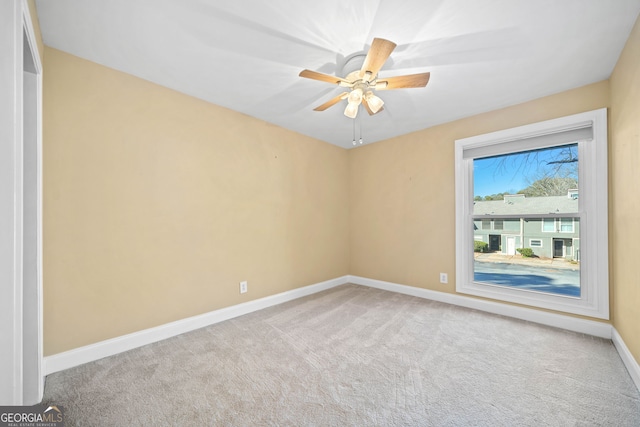 carpeted empty room with ceiling fan