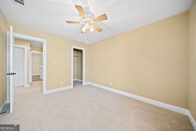 unfurnished bedroom featuring ceiling fan and light carpet