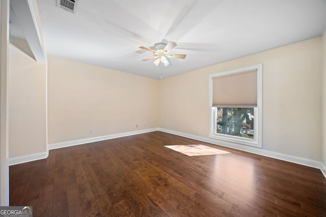 empty room with dark hardwood / wood-style floors and ceiling fan