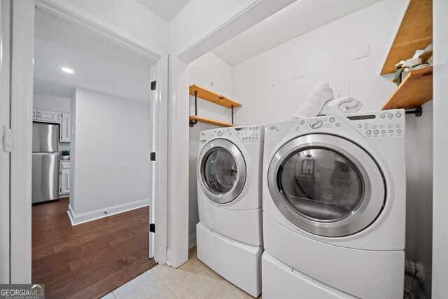 laundry room with light tile patterned floors and separate washer and dryer