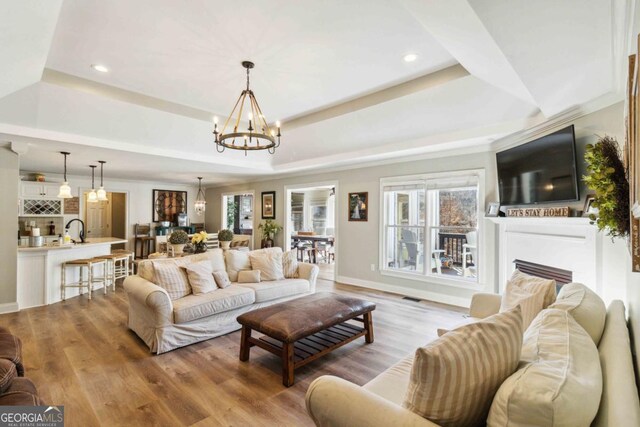 kitchen featuring white cabinets, sink, pendant lighting, a breakfast bar, and stainless steel appliances