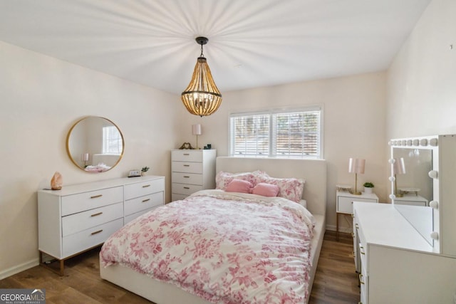 bedroom with ceiling fan, wood-type flooring, a tray ceiling, and access to outside