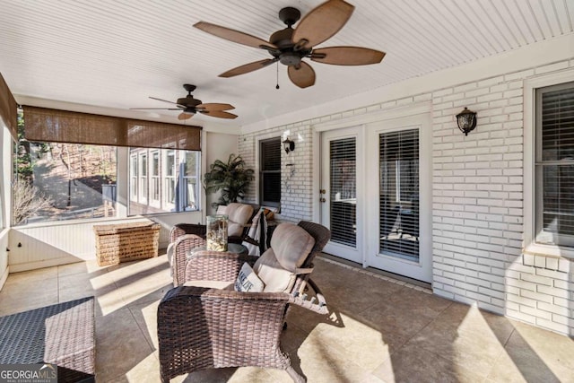 sunroom featuring ceiling fan