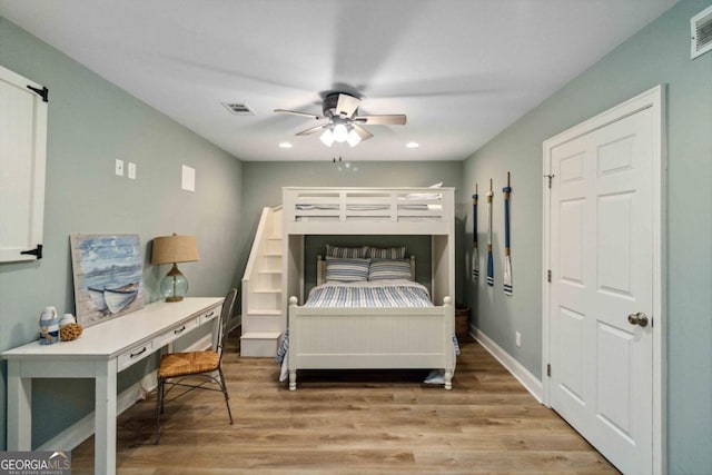 bedroom with ceiling fan and hardwood / wood-style flooring