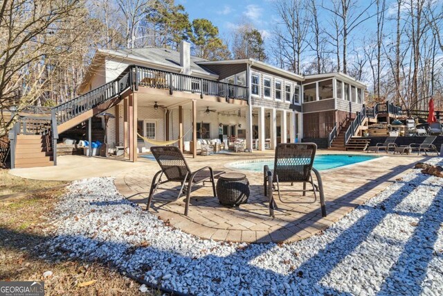 back of property featuring ceiling fan, a patio area, and a sunroom