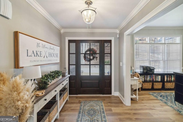 dining space with light hardwood / wood-style flooring, a notable chandelier, and ornamental molding