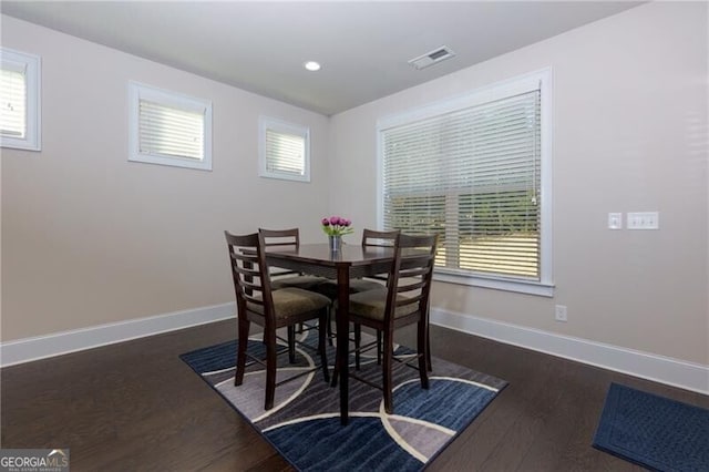 dining area with dark hardwood / wood-style flooring and a wealth of natural light