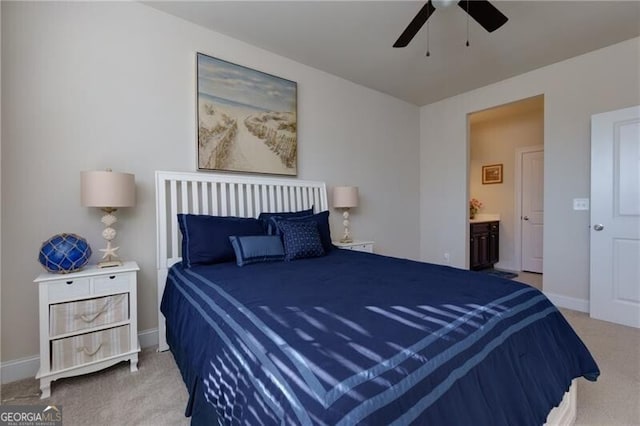 carpeted bedroom with connected bathroom and ceiling fan