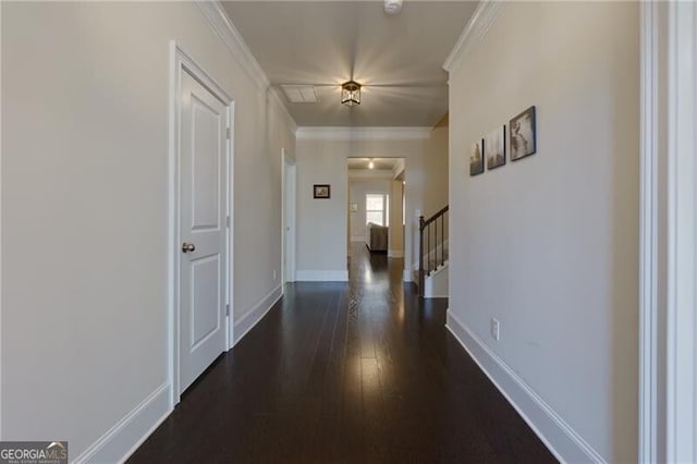 hallway with dark hardwood / wood-style floors and crown molding