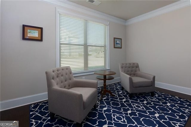 living area featuring crown molding and plenty of natural light