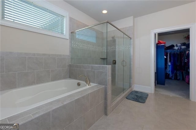 bathroom featuring plus walk in shower and tile patterned flooring