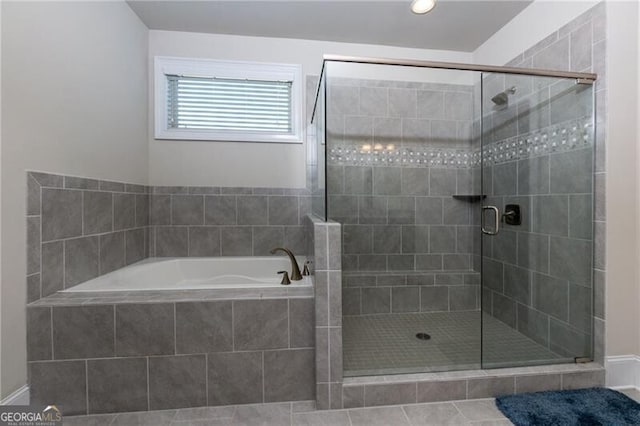 bathroom with tile patterned flooring and separate shower and tub