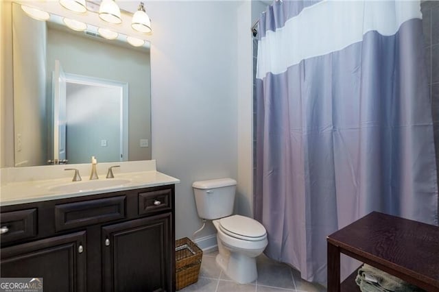 bathroom featuring tile patterned flooring, vanity, and toilet