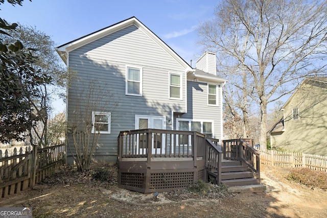 back of house featuring a wooden deck