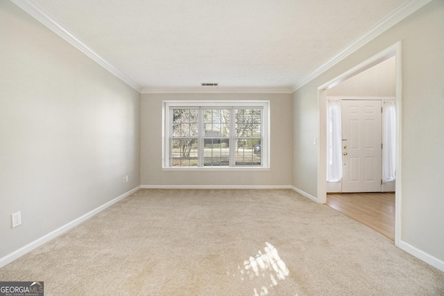 spare room with light carpet and ornamental molding