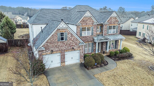 view of front of home featuring a garage and a front lawn