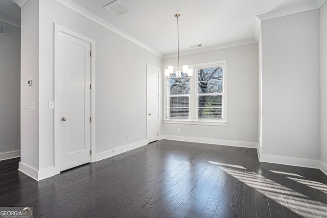 spare room with dark hardwood / wood-style floors, an inviting chandelier, and ornamental molding