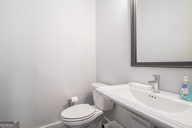 bathroom with toilet and sink