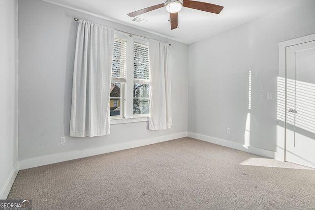 spare room featuring carpet and ceiling fan